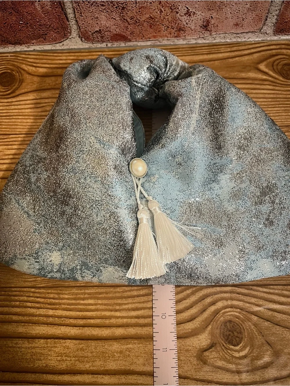 Stylish Blue Metallic Knot Bag with Tassel and Pearl Accent